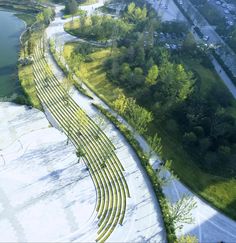 an aerial view of a park with trees and water