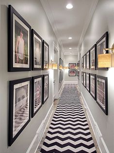 a long hallway with pictures hanging on the wall and an instagramr below it