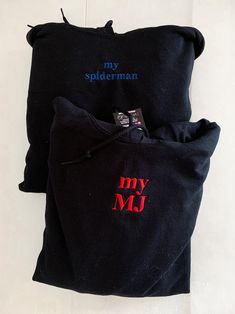 two black bags with red and blue designs on them, one has a tag that says my spiderman