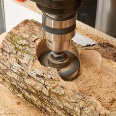 a drill is in the middle of a piece of wood