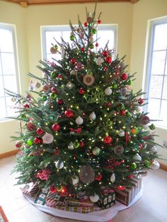 a decorated christmas tree in the corner of a room