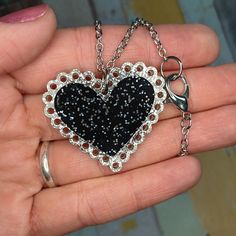 "Embrace a bit of Darkness in your Lovely Heart when you wear this cute Black Heart Glitter Lace Doily Valentines Day Statement Necklace! 🖤 Fun 2 layered pendant is made of laser cut Black Glitter Infused Acrylic and Silver Glitter Infused Acrylic! 🖤 Big and eye-catching, this Sparkly Black Heart Doily Statement Necklace measures 1.5\" from side to side and comes on a 24\" long silver color chain with large lobster clasp! 🖤 This Eye-Catching Black and Silver Valentines Day Necklace is a great Party Heart Necklace With Adjustable Chain, Party Heart Pendant Necklace With Adjustable Chain, Heart Pendant Necklace With Adjustable Chain For Party, Adjustable Heart Pendant Necklace For Party, Cute Heart Necklace For Valentine's Day Party, Valentine's Day Heart Pendant Necklace For Party, Heart-shaped Necklace For Mother's Day Party, Heart Necklace For Mother's Day Party, Mother's Day Heart Pendant Necklace For Party