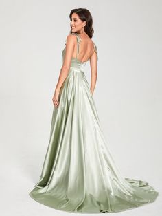 a woman in a long green dress looking back