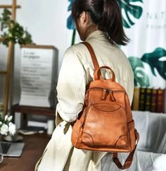 Step up your fashion game with this stylish ladies' backpack. Crafted from genuine leather, this waterproof backpack is both practical and fashionable. It features a soft handle strap for comfortable carrying and offers ample interior and exterior pockets, including a convenient silt pocket. Handmade with attention to detail, this vintage-inspired backpack is a must-have accessory for any fashion-forward woman.SpecificationsBrand Name: GeraldBlack Origin: Mainland ChinaCN: GuangdongMain Material: Genuine LeatherGenuine Leather Type: Cow LeatherLining Material: Organic CottonBackpacks Type: SoftbackInterior: Cell Phone PocketInterior: Interior Zipper PocketHandle/Strap Type: Soft HandleExterior: Silt PocketDecoration: NONEClosure Type: zipperTechnics: EmbossingCapacity: Below 20 LitreItem T Large Capacity Leather Bags For Back To School, Back To School Large Capacity Leather Bags, Large Capacity Leather Backpack For Back To School, Large Capacity Leather Backpack For School, Back To School Softback Shoulder Bag, Casual Leather Backpack For On-the-go, Trendy Brown Leather Backpack For Back To School, Leather Shoulder Bag With Zipper Closure, Back To School Leather Softback Bag