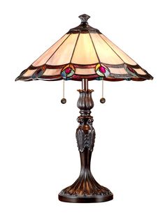 a lamp that is sitting on top of a wooden stand with a glass shade over it