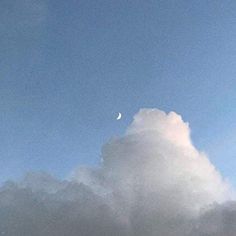 the sky is very cloudy and there are clouds in front of it with a half moon