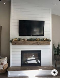 a flat screen tv mounted above a fireplace