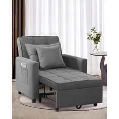 a gray chair and ottoman in a living room