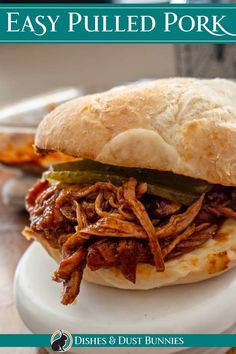 a pulled pork sandwich on a bun with pickles