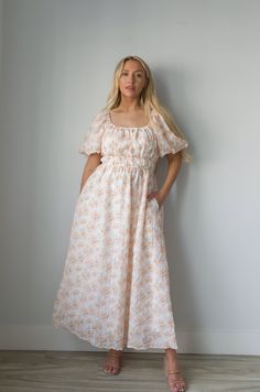 Expertly crafted for style and comfort, our Blossom Floral Print Midi Dress in Peachy is perfect for any occasion. Featuring charming puff sleeves, a flattering elastic waist, and convenient pockets, this dress effortlessly combines classic elegance with modern functionality. The square neck adds a touch of sophistication, making it a must-have for any wardrobe. square neckline puff sleeves elastic waist lined 100% polyester true to size model is wearing a medium Billowy Puff Sleeve Dress For Spring Brunch, Fitted Waist Midi Dress For Brunch, Spring Daywear Puff Sleeve Dress With Relaxed Fit, Spring Puff Sleeve Relaxed Fit Dress For Daywear, Spring Daywear Relaxed Fit Puff Sleeve Dress, Spring Relaxed Fit Puff Sleeve Dress For Daywear, Spring Maxi Dress With Elastic Puff Sleeves, Spring Maxi Dress With Gathered Waist And Short Sleeves, Spring Maxi Dress With Puff Sleeves And Gathered Neckline