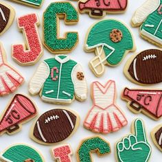 some decorated cookies with different designs and colors on them, including one for the letter j