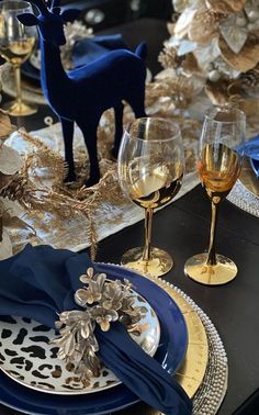 the table is set with blue and gold decorations