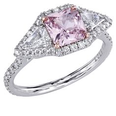 a pink diamond and white topaz ring with diamonds on the sides, set in 18k