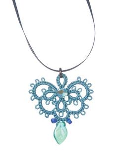 a blue beaded necklace on a leather cord with a pendant hanging from the front