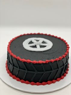 a black and red cake sitting on top of a white plate