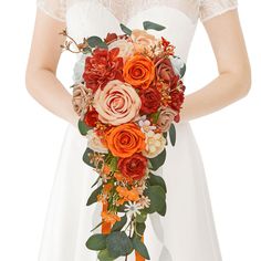 a woman holding a bouquet of flowers in her hands and wearing a white dress with an orange sash