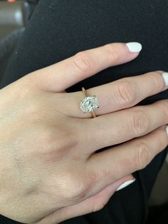 a woman's hand with a diamond ring on it