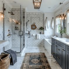 a large bathroom with white tile and black cabinets