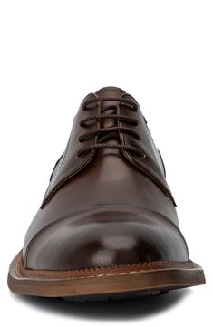 A classic cap toe brings a polished aesthetic to a contemporary derby made of supple leather. Lace-up closure Cushioned footbed Cap toe Leather upper and lining/rubber sole Imported Brown Cap Toe Derby With Goodyear Welt, Brown Cap Toe Derby With Goodyear Welted, Brown Dress Shoes With Rubber Heel Cap For Derby, Business Casual Cap Toe Derby Shoes, Cap Toe Dress Shoes With Leather Lining, Classic Snip Toe Oxfords For Derby, Business Derby Oxford Shoes With Cap Toe, Oxford Dress Shoes With Leather Lining And Cap Toe, Oxford Dress Shoes With Cap Toe And Leather Lining