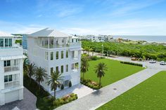 an artist's rendering of a two - story house on the beach with palm trees