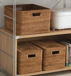 two wicker baskets on top of a shelf