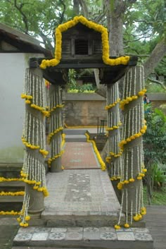 an outdoor shrine with yellow flowers on it