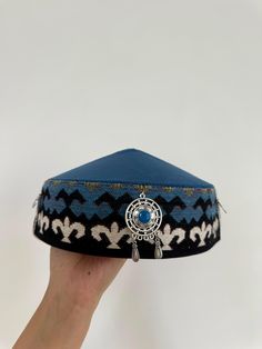 This stunning Kazakh & Kyrgyz headdress is a traditional piece of clothing worn in Central Asia, particularly in Kazakhstan and Kyrgyzstan. It is an important part of the region's cultural heritage, and has been worn by women for centuries. Made with high-quality materials and featuring intricate embroidery and beadwork, this headdress is a true work of art. The design is inspired by the Silk Road, the ancient trade route that connected China to the Mediterranean. The headdress is adorned with c Festival Headband, The Silk Road, Cultural Festival, Intricate Embroidery, Silk Road, World Cultures, Central Asia, Turbans, Cultural Heritage