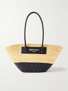 Jimmy Choo's 'Avenue' tote is destined to be worn on glamorous vacations. Woven from lightweight raffia in a two-tone design, it's trimmed with studded leather and has elongated shoulder straps. It'll easily fit a bottle of SPF, a book and a small towel. Designer Straw Bag For Summer Shopping, Designer Summer Straw Bag For Shopping, Designer Summer Straw Shopping Bag, Luxury Black Straw Bag For Summer, Luxury Black Summer Straw Bag, Designer Straw Bag For Summer, Designer Straw Bag For Vacation, Designer Summer Straw Bag, Luxury Summer Bag With Leather Trim