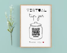 a poster with a qr code on it next to a small white flower and a blue wall