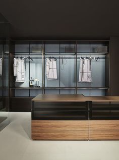 an empty dressing room with clothes hanging on the racks