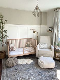 a baby's room with a crib, chair and rug