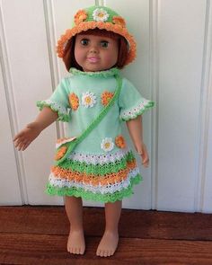 the doll is wearing a green dress and hat with flowers on it's head