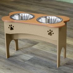 an elevated dog bowl stand with two bowls on it