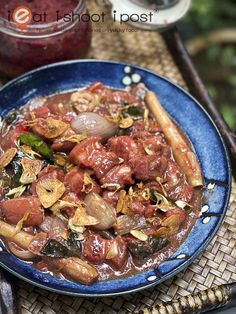 a blue plate topped with meat and vegetables