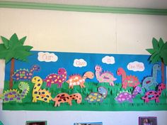 a bulletin board with dinosaurs and palm trees