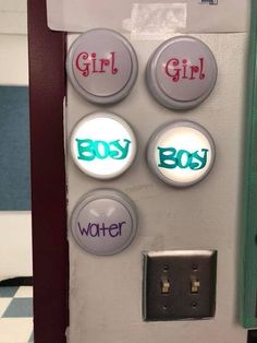 three buttons that say girl, boy and water on the side of a refrigerator door