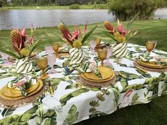 the table is set with pineapples and other tropical items