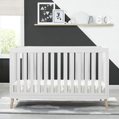 a white crib in a black and white room