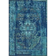 a blue rug with an ornate design on the front and back side, in various colors