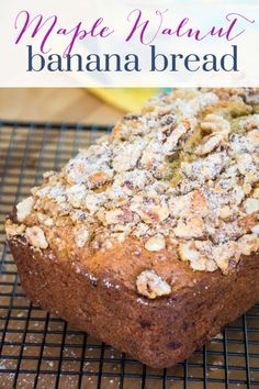 a close up of a banana bread on a cooling rack with the words maple walnut banana bread