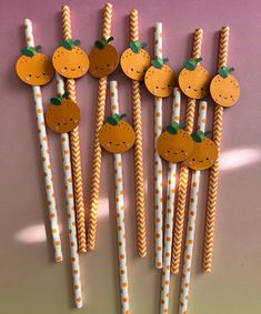 several orange straws are arranged in the shape of pumpkins