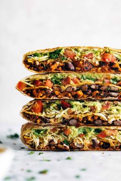 four tacos stacked on top of each other