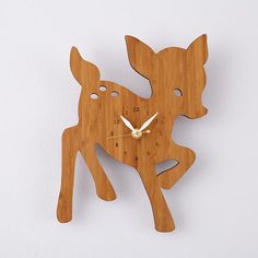 a wooden clock with a deer design on it