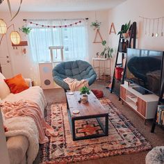 a living room filled with furniture and a flat screen tv sitting on top of a wooden table