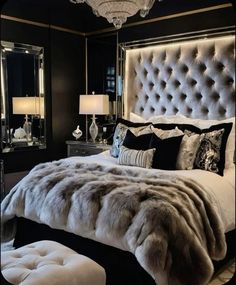 a luxurious bedroom with black walls and white bedding