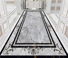 the floor is made up of marble and has black trimmings, with an intricate design on it