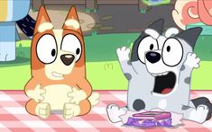 two cartoon dogs sitting at a picnic table with food on the ground in front of them