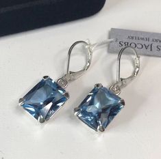 Beautiful Blue Spinel Lever-back Earrings * Emerald Cut Blue Spinel measures 12mm x 10mm  * 12cts total Gemstone weight * Lever-back Fastening  * Solid Sterling Silver Hallmarked & Gift Ready! Matching Pendant Necklace or Ring Also Available! These Gemstones are Laboratory Grown. They are identical to the Natural Stone in every way including Chemistry, Composition and Hardness with excellent clarity & color refraction.  TIMELESS, BEAUTIFUL & UNIQUE FINE ART JEWELRY Elegant Blue Jewelry With Lever Back, Rectangular Blue Earrings For Anniversary, Blue Jewelry With Lever Back Ear Wires For Anniversary, Earrings Emerald, Trending Jewelry, Blue Spinel, Gifts For Fiance, Real Jewelry, Fine Art Jewelry