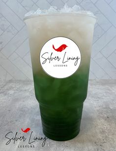 a green and white drink sitting on top of a table