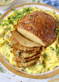 a plate topped with meat and mashed potatoes